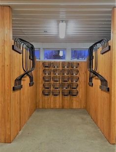 an empty room with wooden partitions and baskets on the wall in front of it