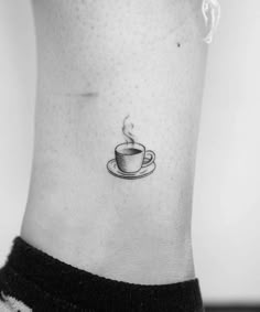 a black and white photo of a coffee cup on the ankle