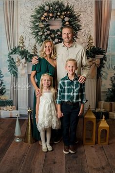 a family posing for a photo in front of a christmas tree