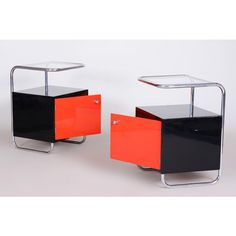 two black and orange side tables on wheels