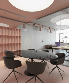 a glass table surrounded by chairs in a room with pink walls and shelving behind it