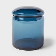 a blue glass jar with a black lid