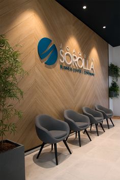 chairs are lined up in front of a wall with the logo sorolla on it