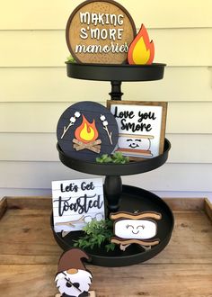 three tiered tray with signs and magnets on it