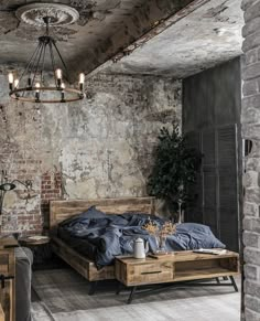 a rustic bedroom with exposed brick walls and an old - fashioned chandelier hanging from the ceiling