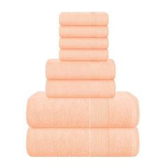 six peach towels stacked on top of each other