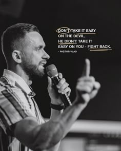 a man holding a microphone in his right hand with a quote on the side that says, don't take it easy