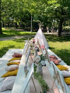 a long table with flowers and teepees on it