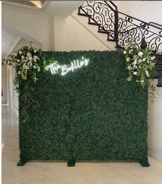 the reception table is set up with greenery and white flowers on it's side