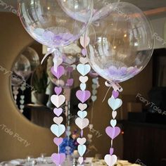 balloons with hearts hanging from them on a table