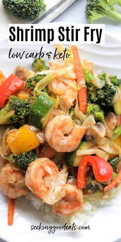 shrimp stir fry with broccoli, carrots and rice on a white plate