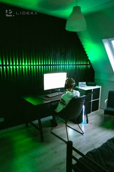 a person sitting at a desk in front of a computer