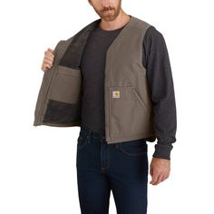 Men's heavyweight duck vest with a Sherpa liningThis men's vest is a versatile layer built to pack on extra warmth right where it matters most. It's made of our signature heavyweight cotton duck, and has a warm Sherpa lining to take on chilly weaFeatures12-ounce, 100% ringspun cotton washed duckSherpa-fleece lining for warmthCarhartt-strong, triple-stitched main seamsFull zip frontDroptail hemTwo sherpa-lined front pocketsTwo inner pocketsBack length: Large regular: 27"; Large tall: 29"Model hei Carhartt Style, Mens Fashion Classy, Men's Outerwear, Vests Mens, Classy Style, Vest Outfits, Chilly Weather, Men's Vest, Sherpa Lined