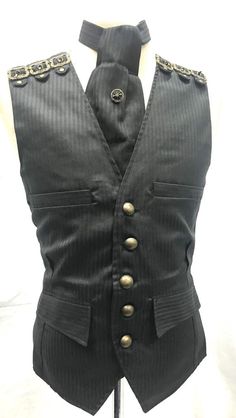 #C2/1This is 3 pcs Waistcoat outfit with 12 brass old fashioned Buckles on Shoulder Details.Cravat and tie pin.Waistcoat has 4 Sides pocket and brass buttons and waist adjuster at the back.It is fully lined.Self tie cravat is same fabric as waist coat with brass compass tie pin included.Please refer to photos.Waistcoat is Available in M40”L/42” XL/44”XXL/46”SizeXXL - To Fit chest 46” (armhole To armhole 48”)Front Length - 25” approximately Back length - 24” approximately Thank you for looking Fitted Striped Business Vest, Striped Fitted Vest For Business, Black Steampunk Vest For Costume Party, Steampunk Black Vest For Costume Party, Gothic Black Vest For Costume Party, Gothic Black Vest For Costume, Black Gothic Costume Vest, Steampunk Style Black Vest For Costumes, Black Fitted Steampunk Vest