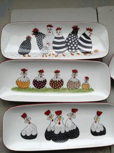 three plates with roosters painted on them are sitting next to each other in the same pattern