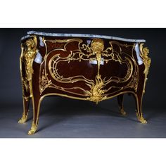 an ornately decorated cabinet with gold accents