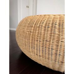 a wicker bench sitting on top of a hard wood floor