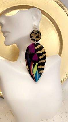 Wow This earring is a show stopper for sure! Dripping paint on one side and black on the other side. This earring can be made in med size. The size pictured is large dropping at 3 1/2 inches.  Please read This earring is made to order. It will take approximately 7 days to ship. Luxury Hand Painted Statement Earrings, Luxury Hand Painted Unique Earrings, African Hand Painted Earrings, Artistic Black Dangle Earrings, Black Hand Painted Drop Earrings, Unique Hand Painted Black Earrings, Artsy Black Earrings With Ear Wire, Bold Black Drop Earrings, Hand Painted Black Earrings