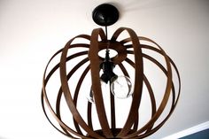 a wooden light fixture hanging from the ceiling