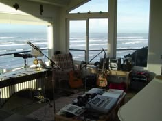 a living room filled with furniture and musical instruments