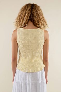 Introducing our Glo Smocked Tank in a light yellow hue. With its smocked texture and boat neck style, it's the perfect elevated basic for spring and summer. Material & Care: Crafted from 97% Rayon and 3% Spandex. Hand wash in cold water with mild detergent. Lay flat to dry. Avoid bleach and dry cleaning. Size & Fit: Model is wearing a size small Light Yellow, Boat Neck, Lay Flat, Smocking, Cold Water, Sweater Dress, Bleach, Hand Wash, Spandex