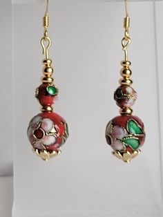 This pair of earrings are made of round red Cloisonné' beads and gold plated beads and findings. Cloisonné is the technique of creating designs on metal vessels (cloisons) with colored-glass paste placed within enclosures made of copper or bronze wires, which have been bent or hammered into the desired pattern.  Custom Orders are always welcome! Cloisonne Earrings, Gold Plated Earrings, Colored Glass, Pink Flowers, Jewelry Earrings Dangle, Copper, Gold Plate, Dangle Drop Earrings, Dangle Earrings