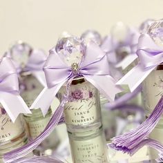 several bottles with purple ribbons tied around them