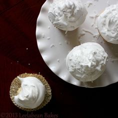 three cupcakes with white frosting on a plate