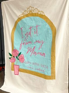 there is a banner that says i got it from my mama and flowers in a vase