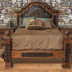 a bed sitting in front of a stone wall