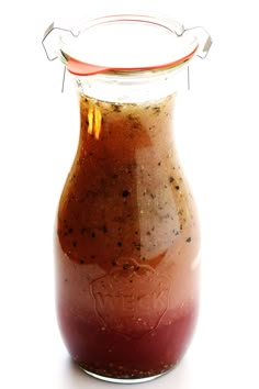 a jar filled with liquid sitting on top of a white table