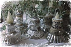 small tin canisters are decorated with silver and white decorations