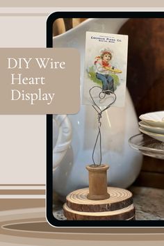 a wooden stand with a card on top of it that says diy wire heart display