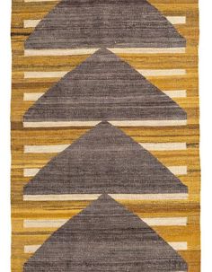 an orange, yellow and grey rug with three different shapes on the bottom one side