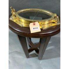 a round table with a price tag attached to the top and an open window on it