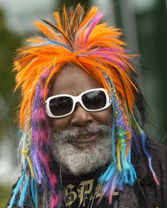 a man with multi colored hair and sunglasses