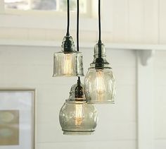 three light fixtures hanging from a ceiling in a kitchen