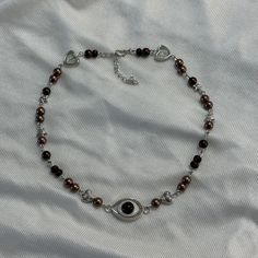 DETAILS: ⋆｡⋆ ☆ obscure eye necklace ✧˖o. brown beaded necklace with silver details and a brown eye charm ₍ᐢ. .ᐢ₎  this is a great unique piece of jewelry<3 i recommend taking it off before swimming or showering 𝜗𝜚 ⊹ ࣪ ˖ *The necklace comes in a cute organza bag packed inside a bubble packaging bag *There are also some stickers, freebies and a little note for you in the package SHIPPING & PROCESSING: *Orders will be shipped from Rhineland-Palatinate via DHL with non-insured shipping (contact me if you want insured shipping but it'll cost more then), I don't assume any liability for lost packages If you have further questions or there's anything wrong with the item you ordered, don't hesitate to contact Brown Glass Beaded Necklaces As Gift, Adjustable Brown Beaded Necklace, Unique Brown Adjustable Crystal Necklace, Artistic Adjustable Brown Necklace, Vintage Brown Adjustable Necklace, Bubble Packaging, Brown Beaded Necklace, Rhineland Palatinate, Brown Eye