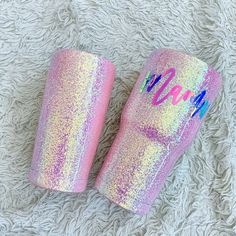 two pink tumblers with the word mama painted on them sitting on a white blanket