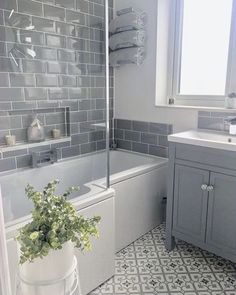 a bathroom with gray tile and white fixtures