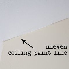 a white wall with a black arrow pointing to the ceiling that says, uneven ceiling paint line