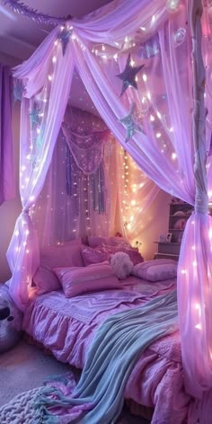 a bed with pink sheets and lights on it