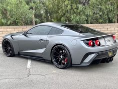 a gray sports car parked in a parking lot