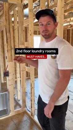 a man is standing in the middle of a room under construction and pointing at something