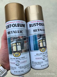 two cans of rustoleum sitting next to each other in someone's hand