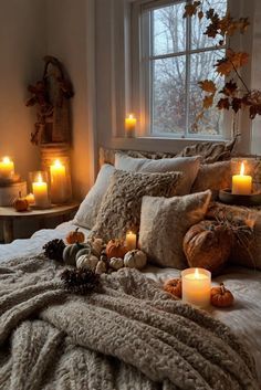 a bedroom with candles and blankets on the bed