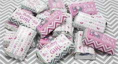 pink and gray baby girl candy bar wrappers on a chevron tablecloth with silver foil