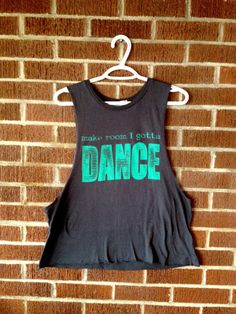 an image of a t - shirt hanging on a brick wall with the word dance printed on it