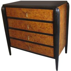 a wooden dresser with three drawers and black handles