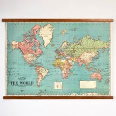 an old world map hanging on the wall